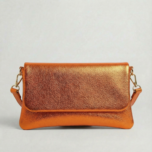Orange metallic leather crossbody bag with a matching color leather strap, displayed on a light gray background.