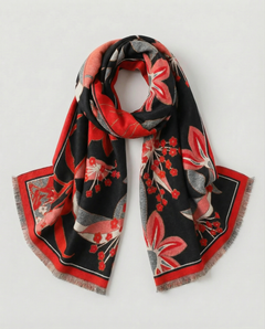 Black scarf with a bold floral pattern in red, pink, gray, and cream tones, featuring a contrasting red border and soft fringed edges, displayed folded on a white background., view 1