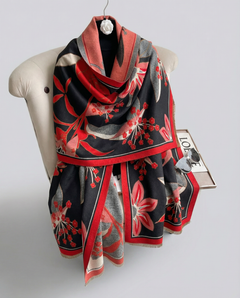 Scarf with red and black floral pattern on a chair against a white background, view 2