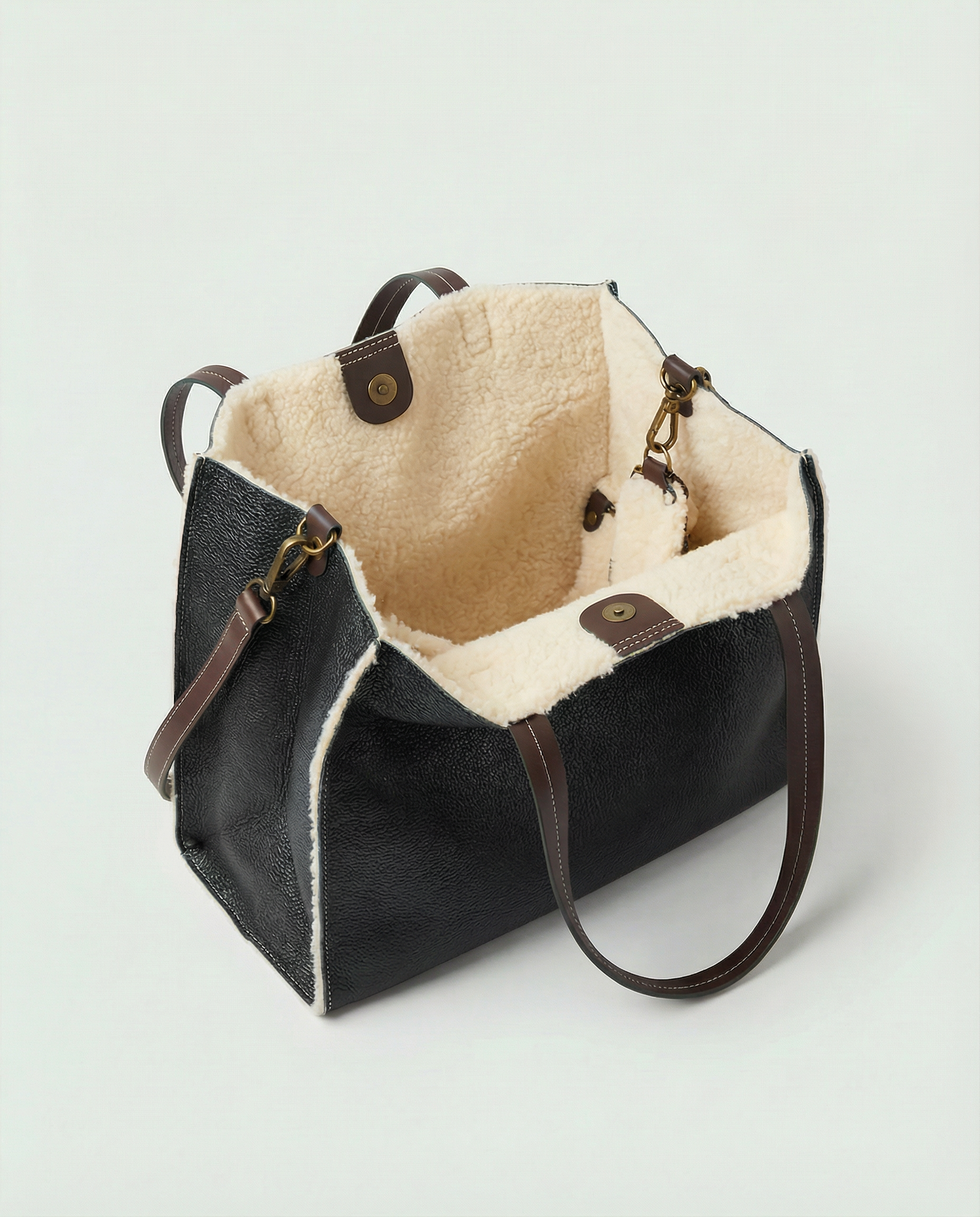 Black tote with beige interior on a light gray background
