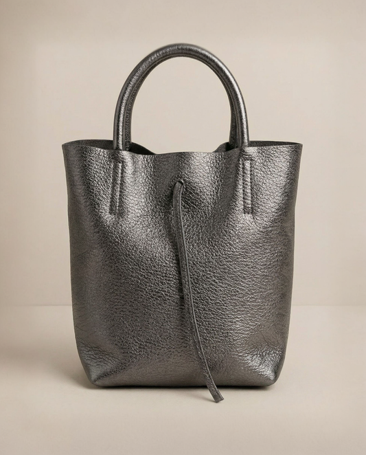 Mini tote in metallic pewter leather with structured silhouette and top handles, sleek and compact design.