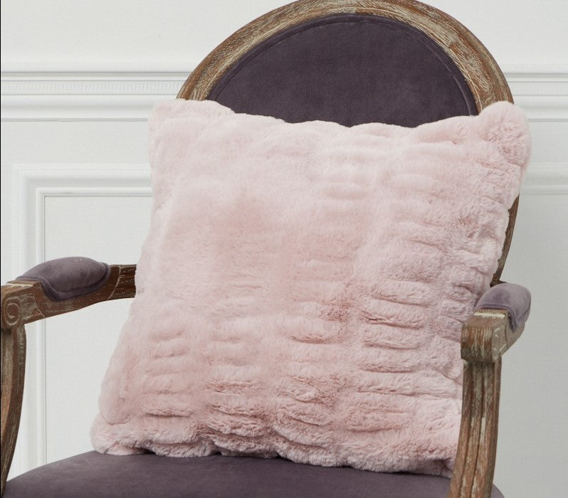 Florence Blush Pillow on a chair.