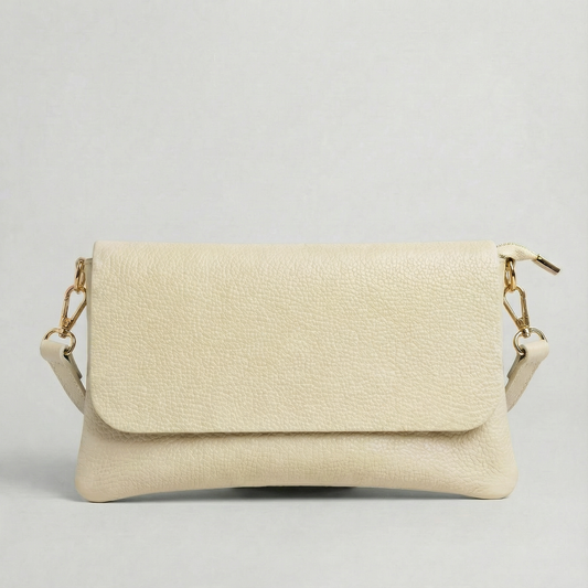 Ivory pebble leather crossbody bag with a matching color adjustable strap, displayed on a light gray background.