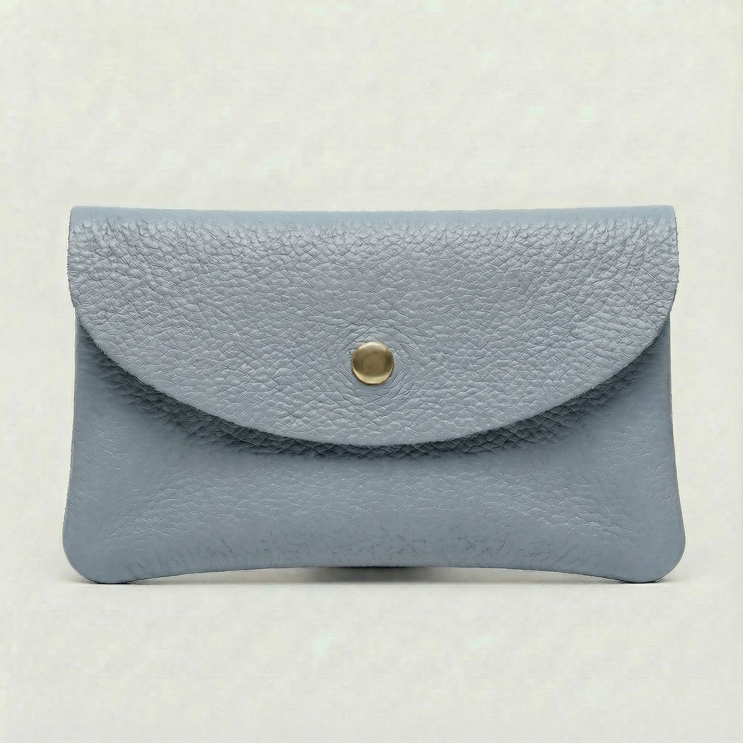 Corn blue leather wallet with a gold button on a light beige background