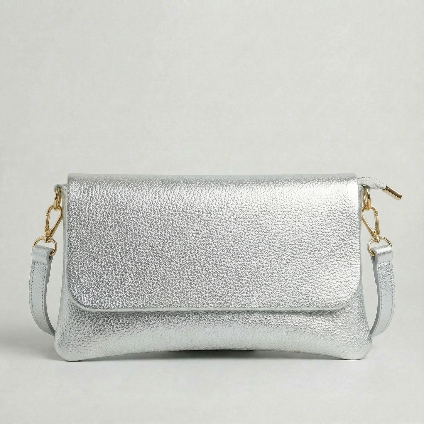 Silver metallic leather crossbody bag with a matching color leather strap, displayed on a light gray background.