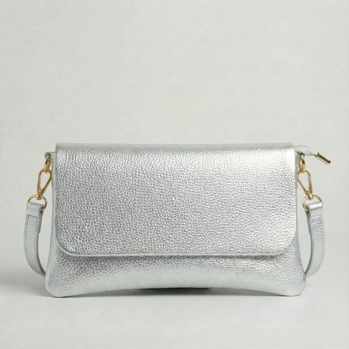 Silver metallic leather crossbody bag with a matching color leather strap, displayed on a light gray background.