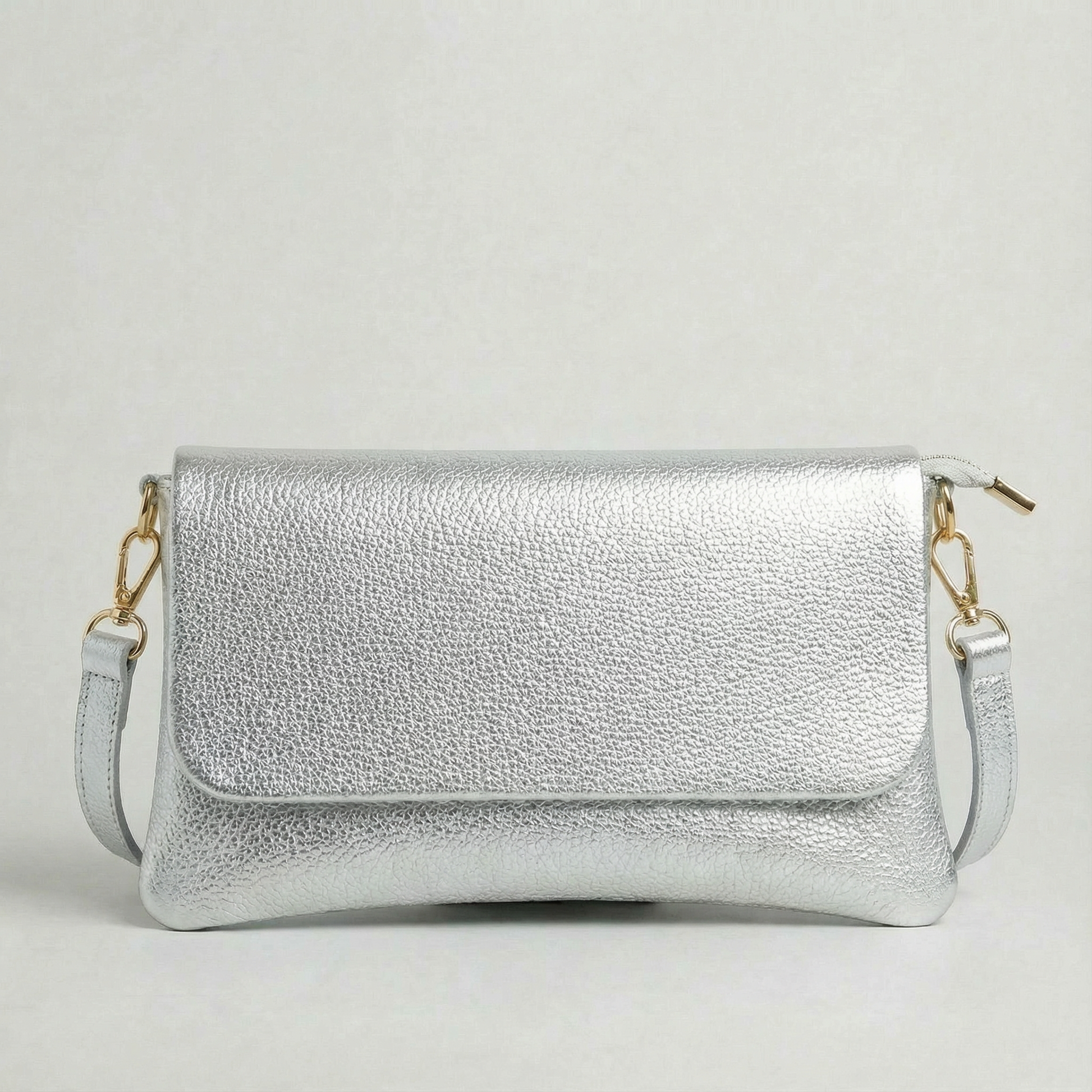 Silver metallic leather crossbody bag with a matching color leather strap, displayed on a light gray background.