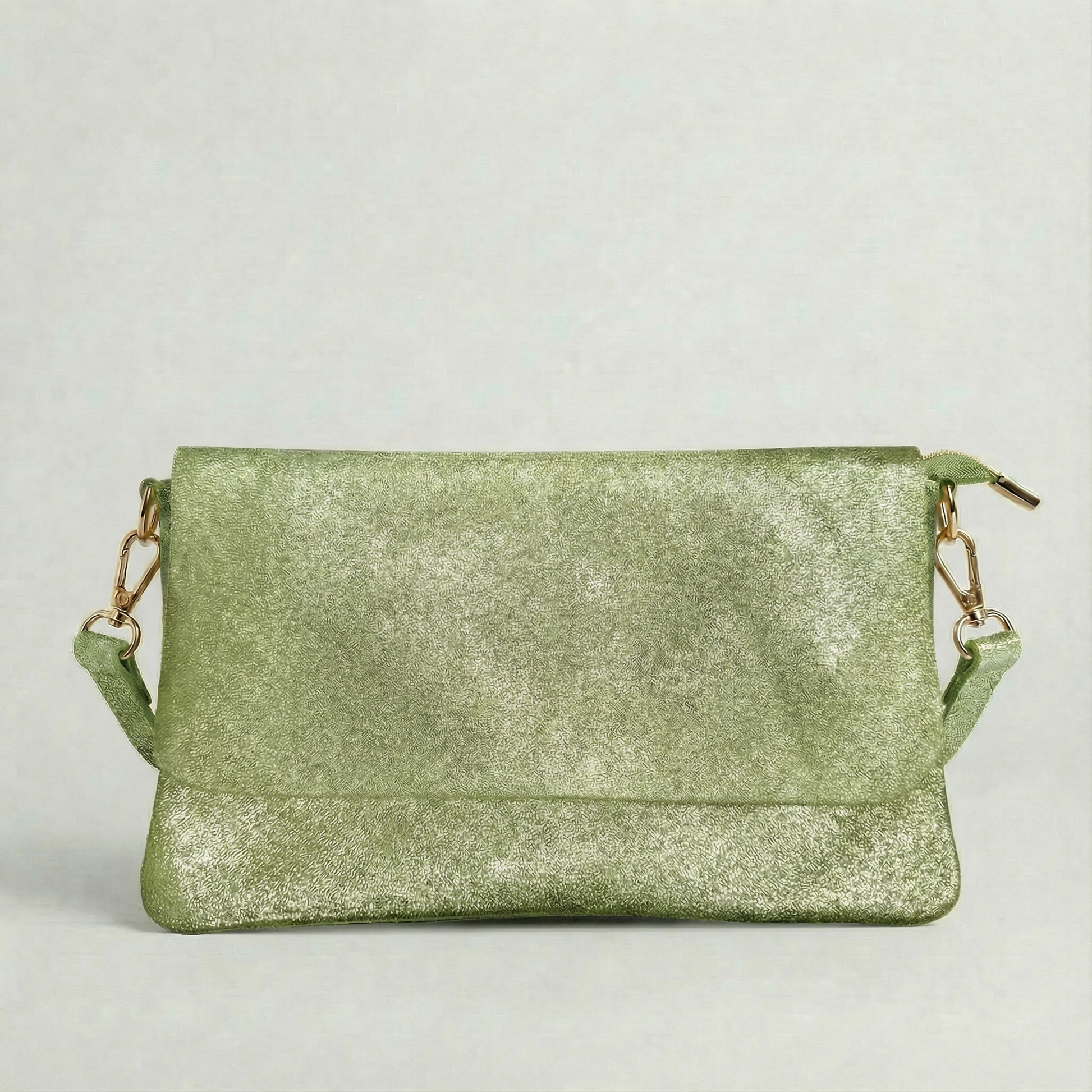 Spruce metallic leather crossbody bag with a matching color leather strap, displayed on a light gray background.  