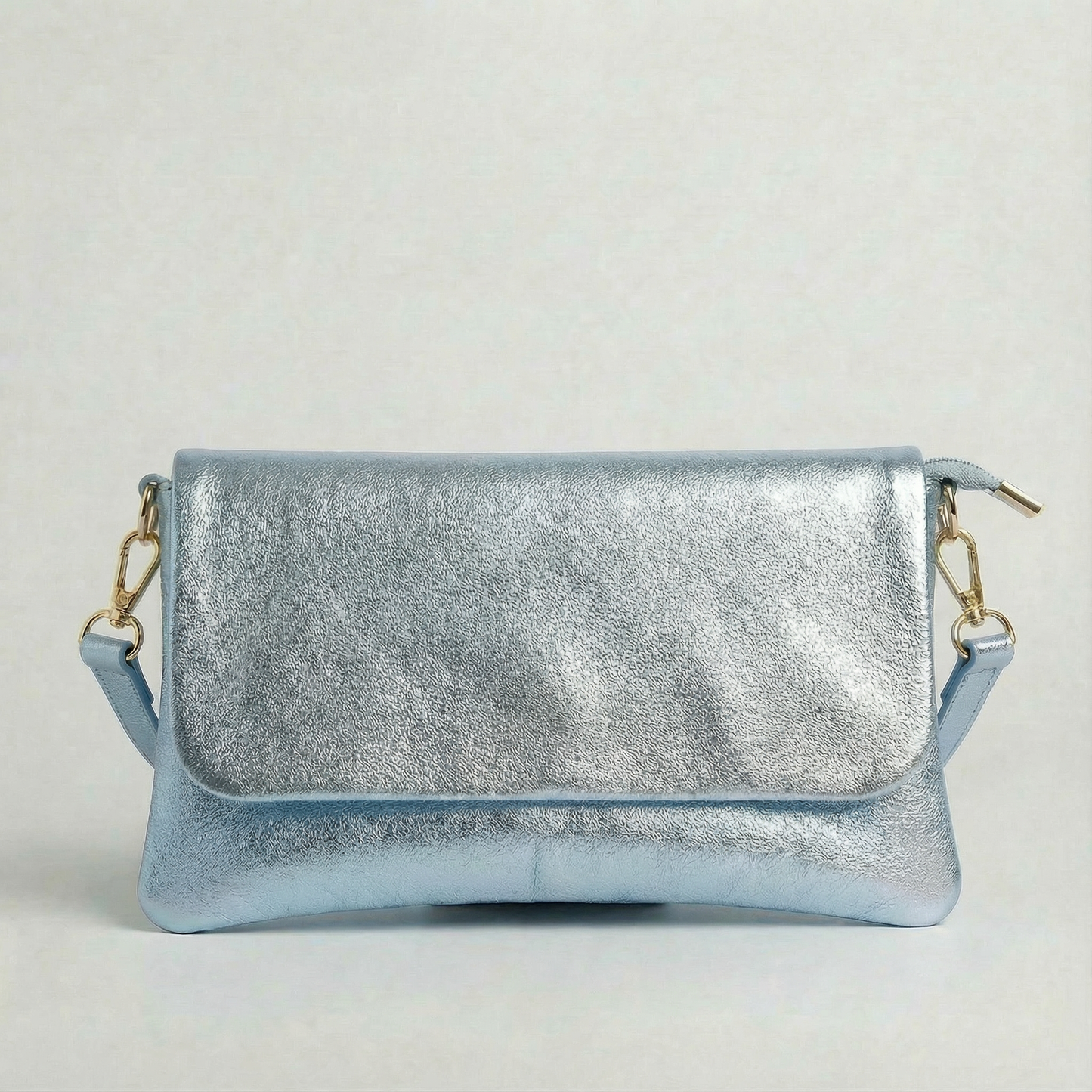 Light Blue metallic leather crossbody bag with a matching color leather strap, displayed on a light gray background.