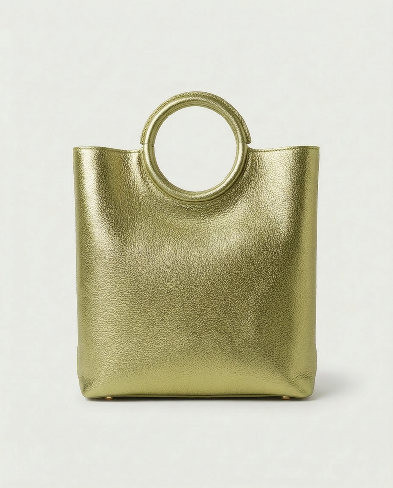 Pistachio metallic ring bag with circular handles on a light gray background