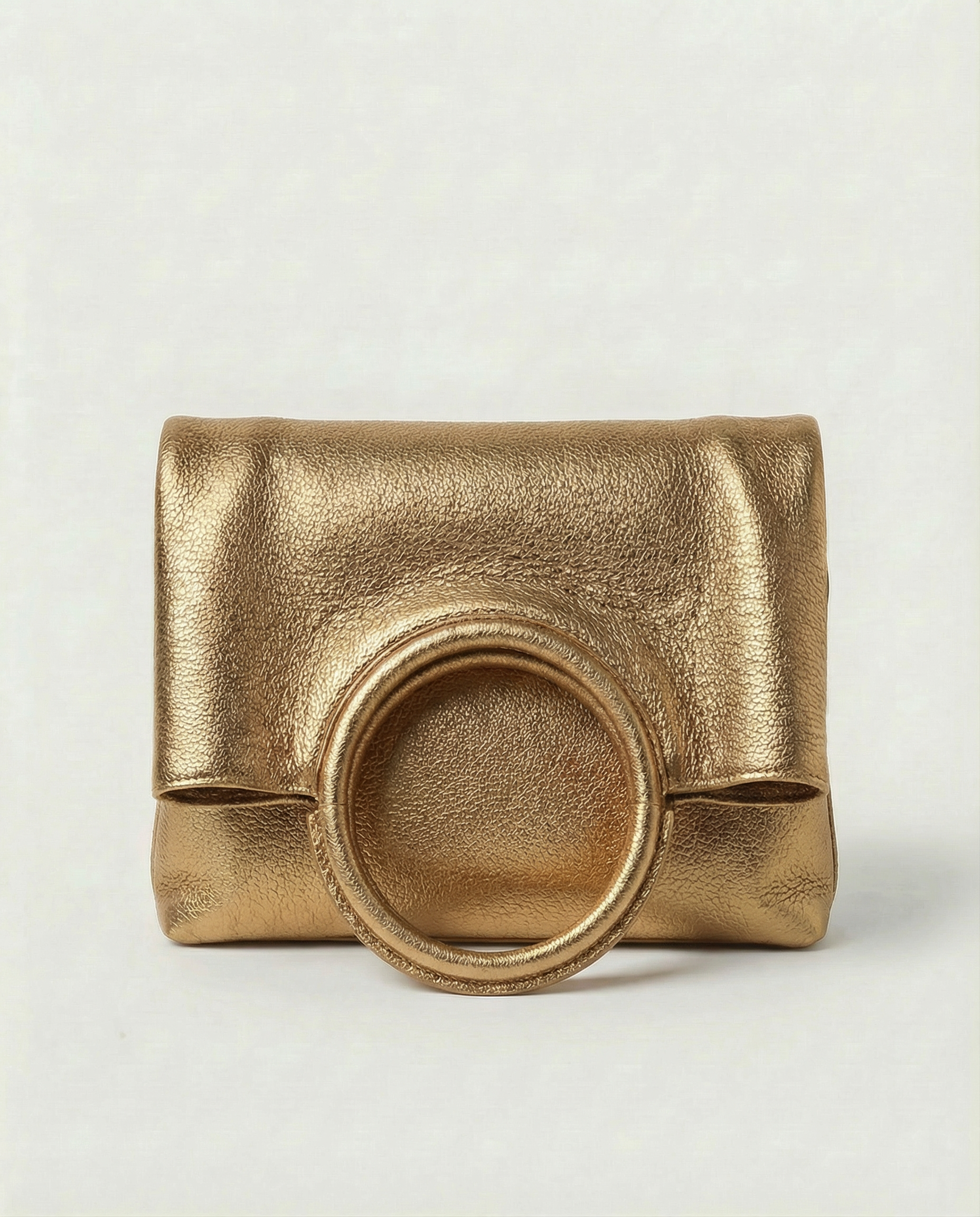 Metallic Antique Gold leather ring bag with circular top handle and structured silhouette, sleek and modern design.
