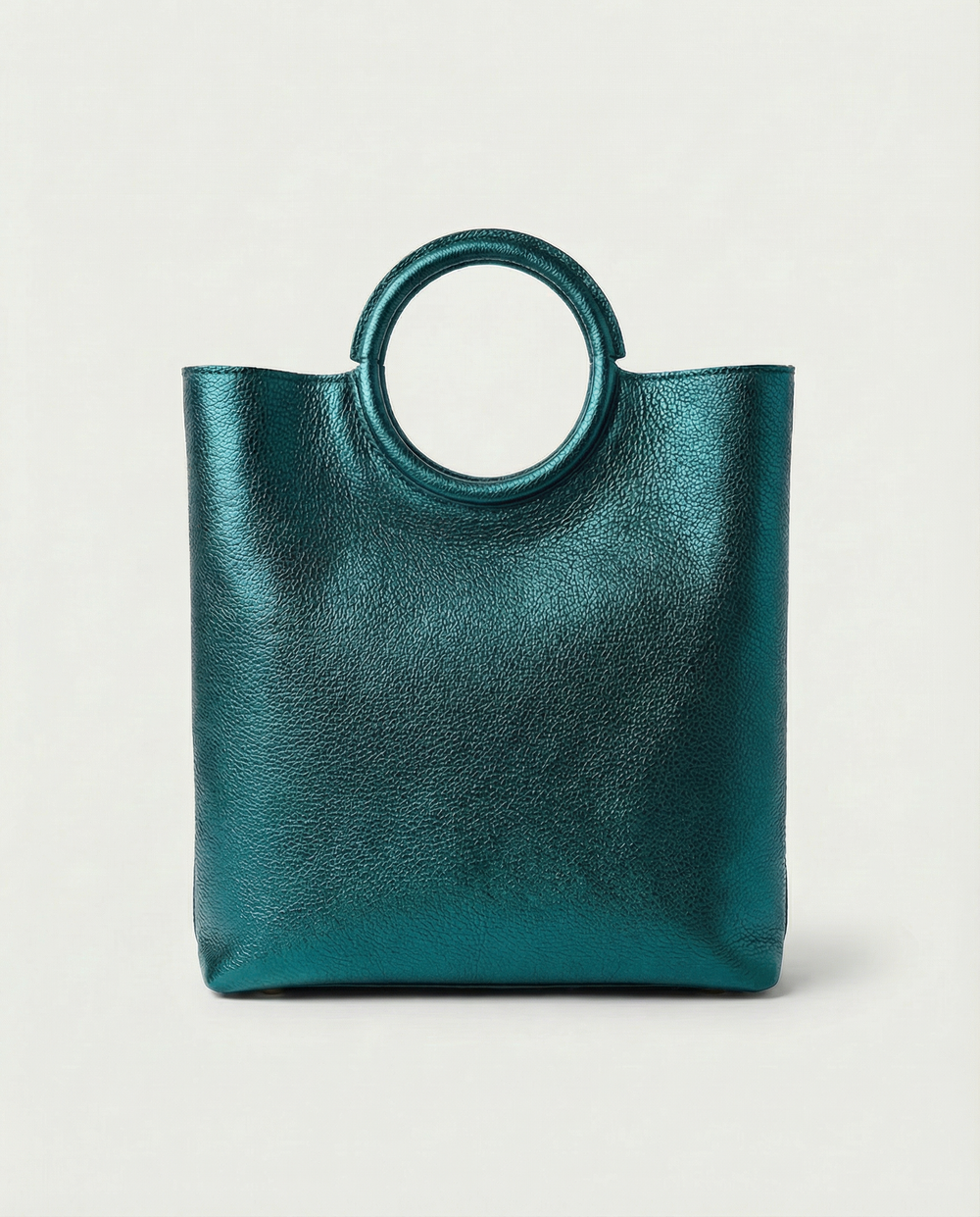 Metallic teal leather ring bag with circular top handle and structured silhouette, sleek and modern design.