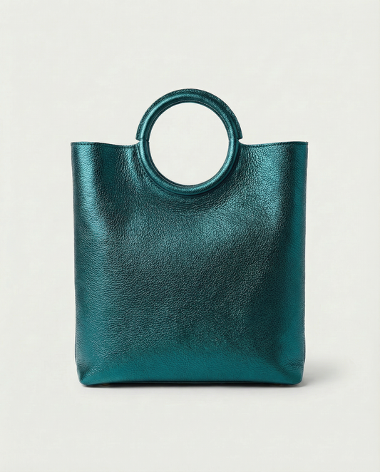 Metallic teal leather ring bag with circular top handle and structured silhouette, sleek and modern design.