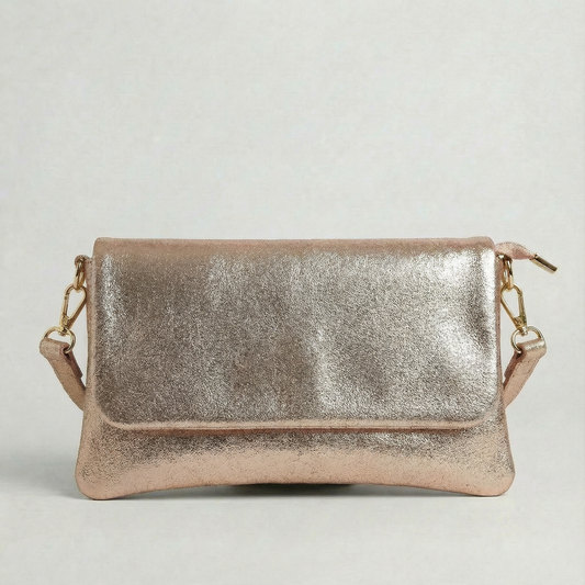 Rose Gold metallic leather crossbody bag with a matching color leather strap, displayed on a light gray background.