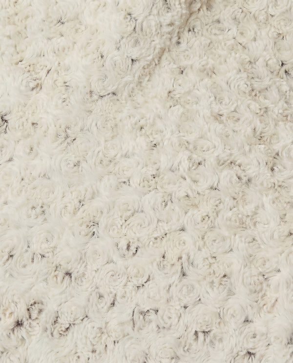 Close-up of a rosebud textured beige throw
