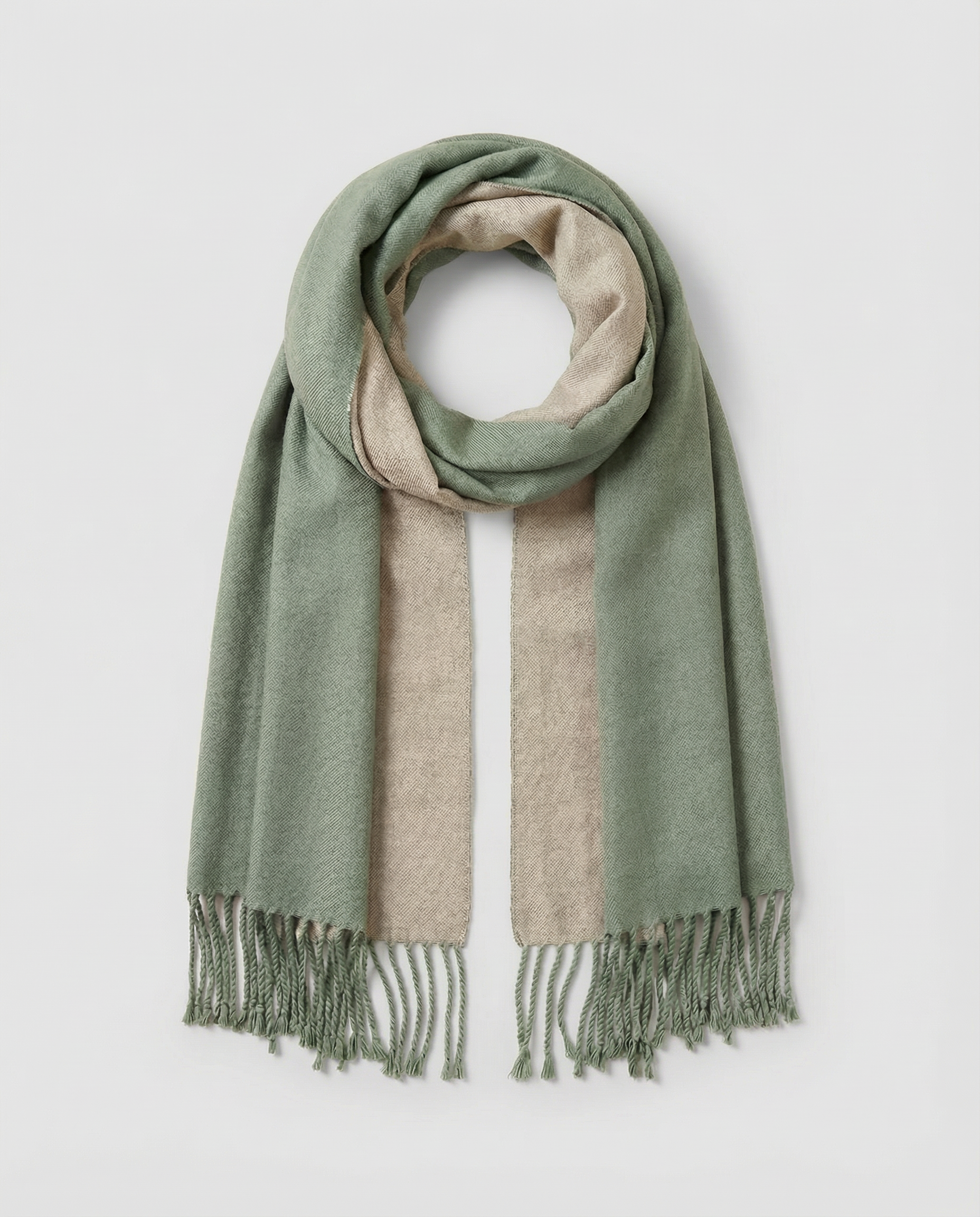 Green and beige striped wrap with fringes on a light gray background