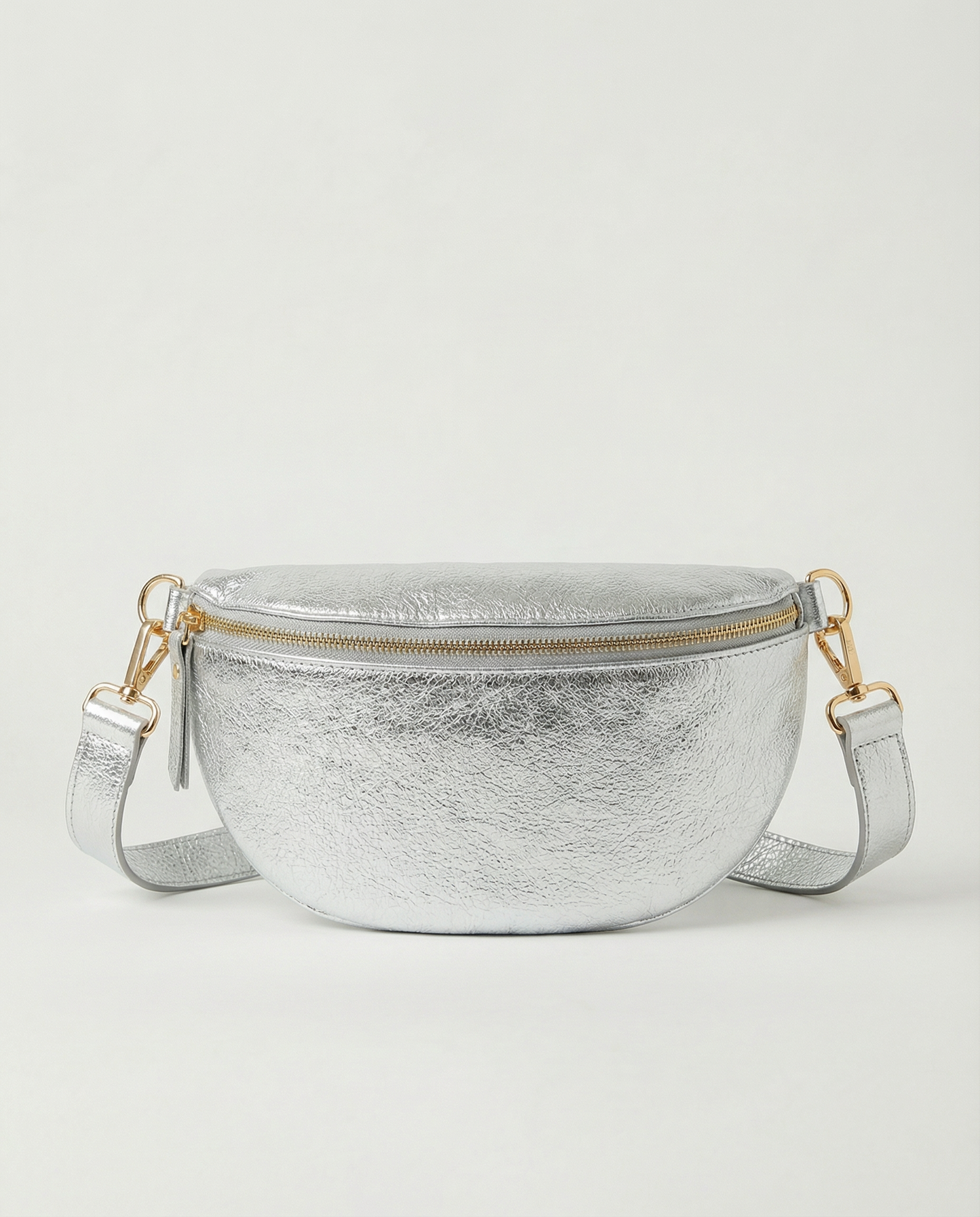 Metallic leather fanny bag in silver with adjustable strap and sleek, compact silhouette designed for hands‑free everyday wear.