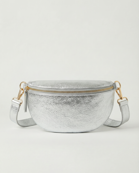 Metallic leather fanny bag in silver with adjustable strap and sleek, compact silhouette designed for hands‑free everyday wear.