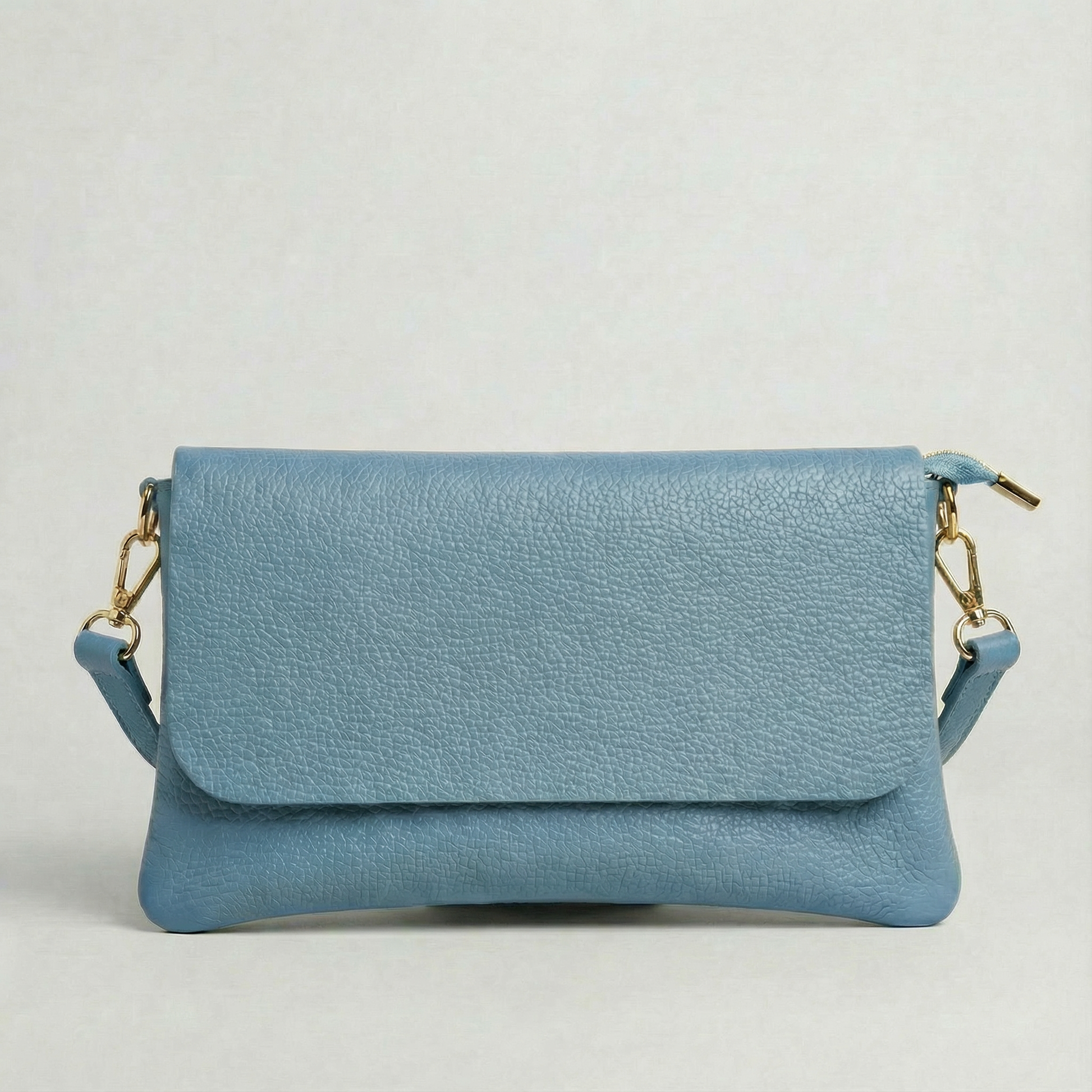 Sky Blue pebble leather crossbody bag with a matching color adjustable strap, displayed on a light gray background.