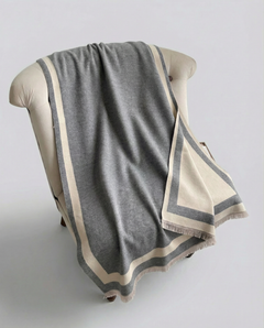Gray and beige striped wrap draped over a chair on a light gray background, view 2