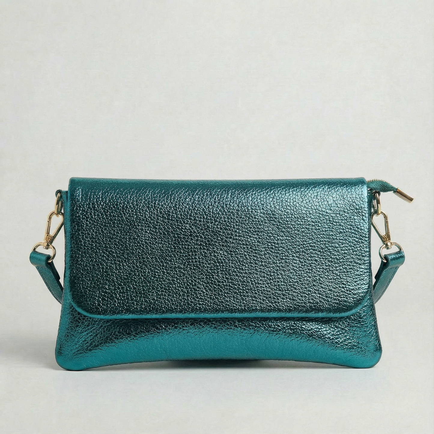 Teal metallic leather crossbody bag with a matching color leather strap, displayed on a light gray background.