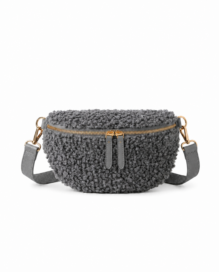 Stylish steel gray teddy fabric and leather fanny bag with an adjustable strap.