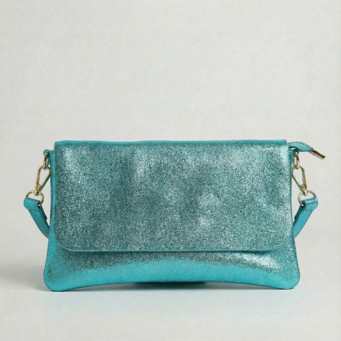 Turquoise metallic leather crossbody bag with a matching color leather strap, displayed on a light gray background.