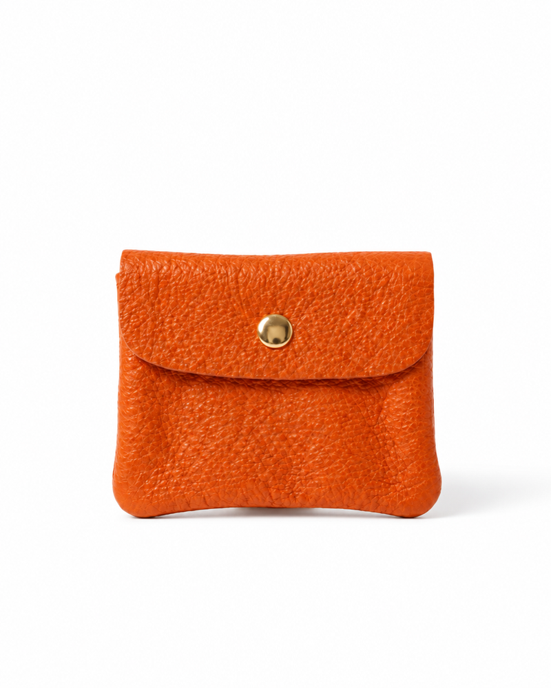 Orange pebble leather wallet collection featuring Mini Coin Wallet, Coin Wallet, and Cellphone Wallet in genuine leather, made in Italy.