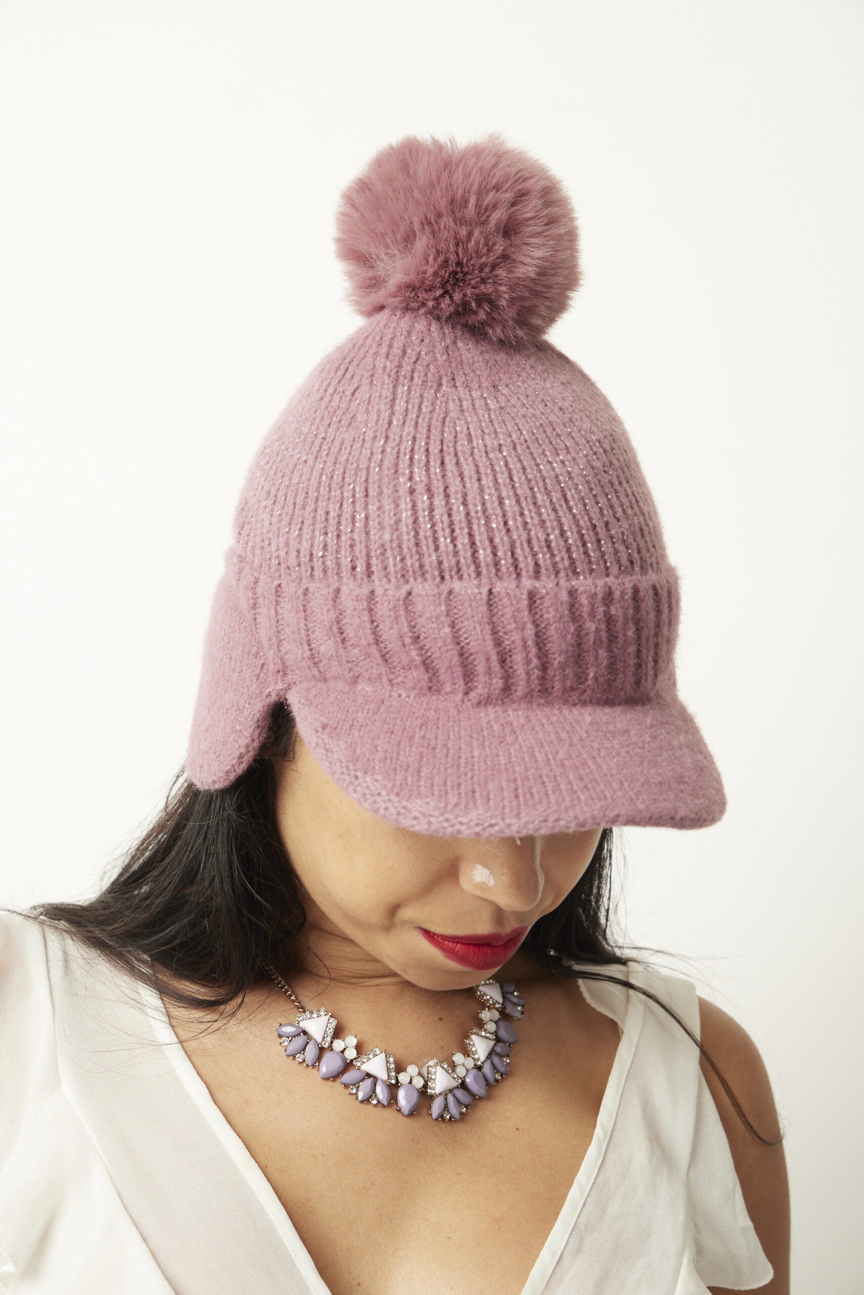 Woman wearing Pink Chiara beanie facing downward
