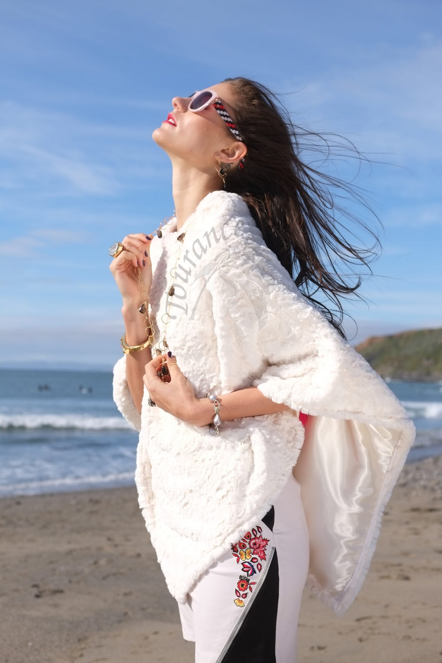Woman in Sunglasses wearing Lux Ivory Poncho on the beach