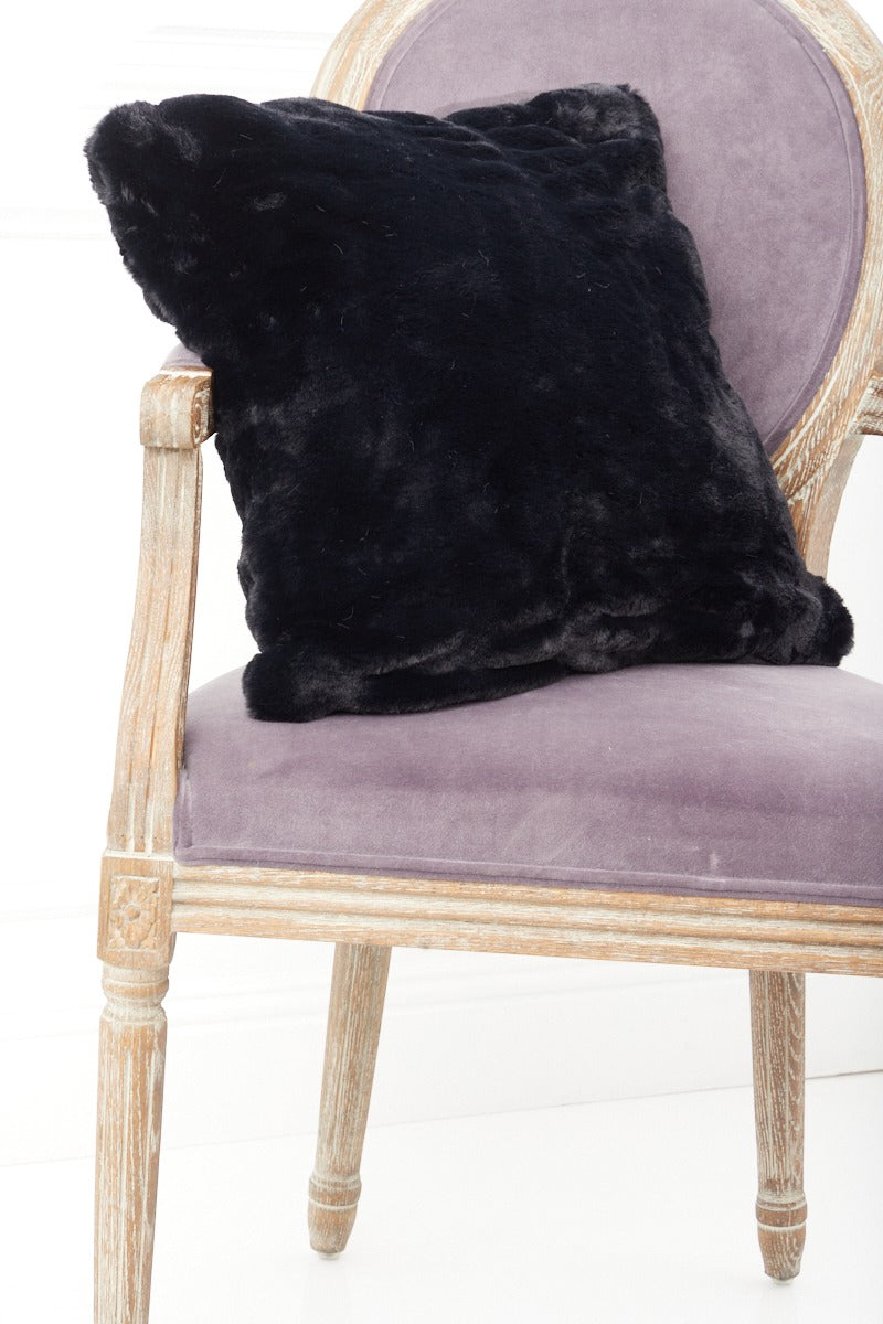 Black Florence Pillow on a pink chair