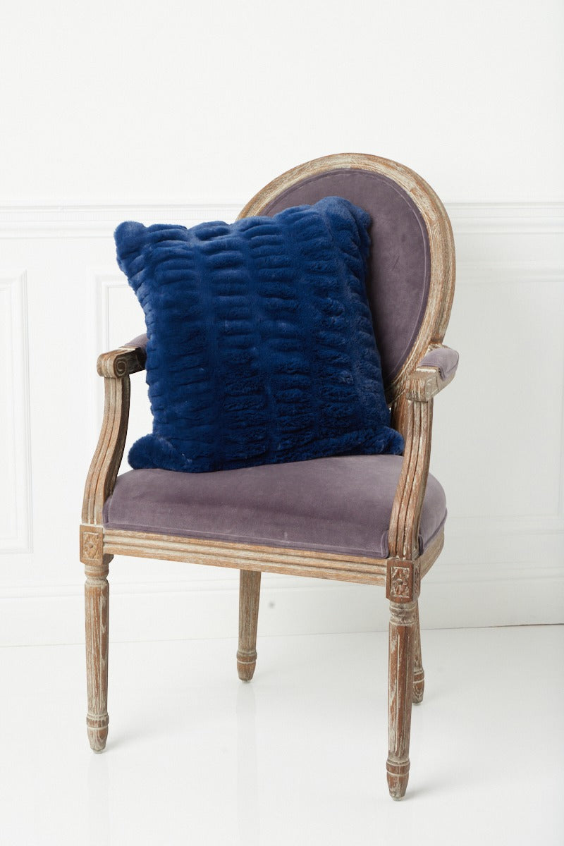 Lower angle of Florence Navy Pillow on chair 
