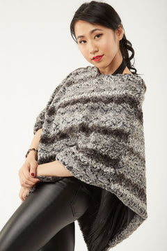 Woman posing wearing a Paloma Poncho – Chocolate and Black Color, view 1