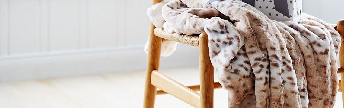 Snow Leopard Baby Blanket with Ivory Rosebud on Chair