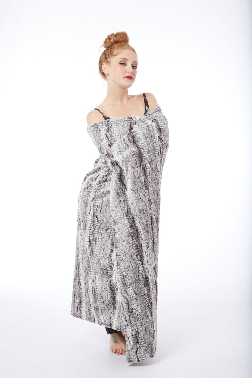 Woman wrapped with Lux Python Throw in Silver