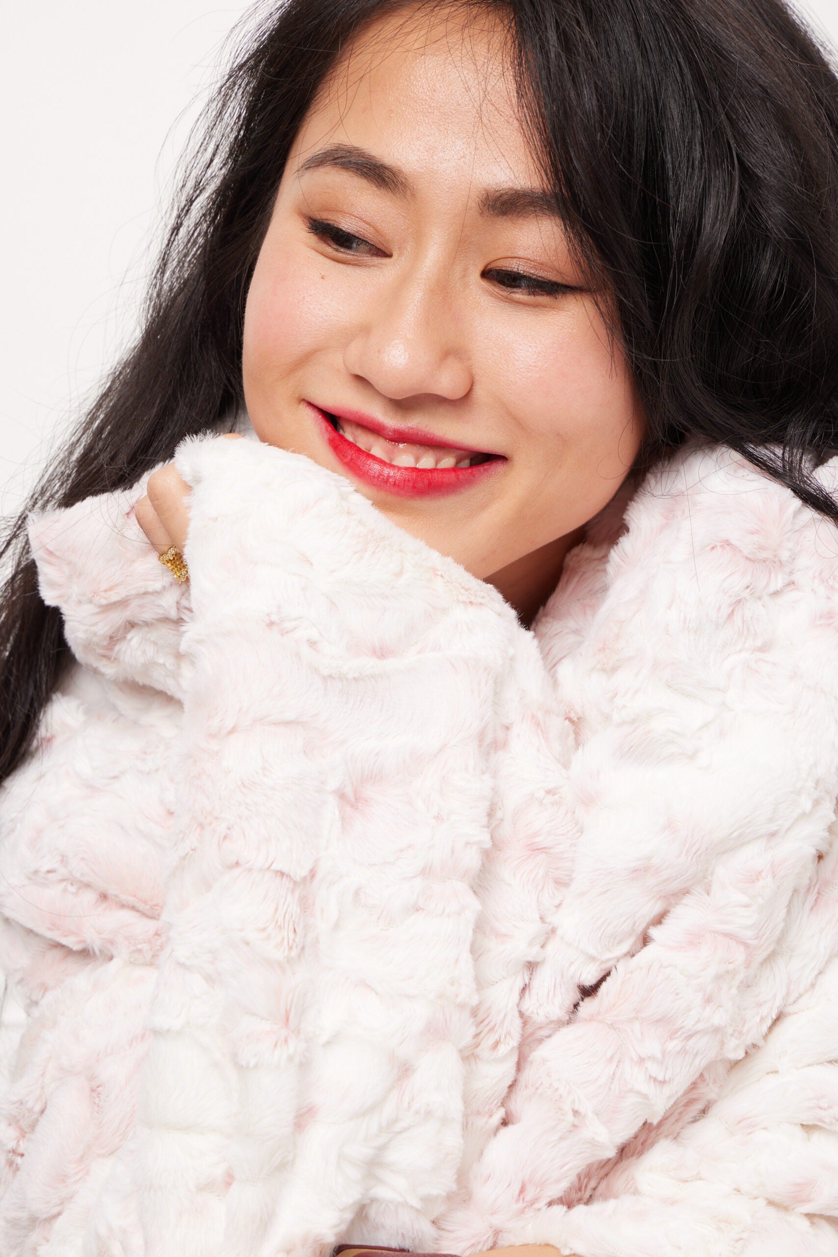 Woman close up shot of Rosewater blanket throw