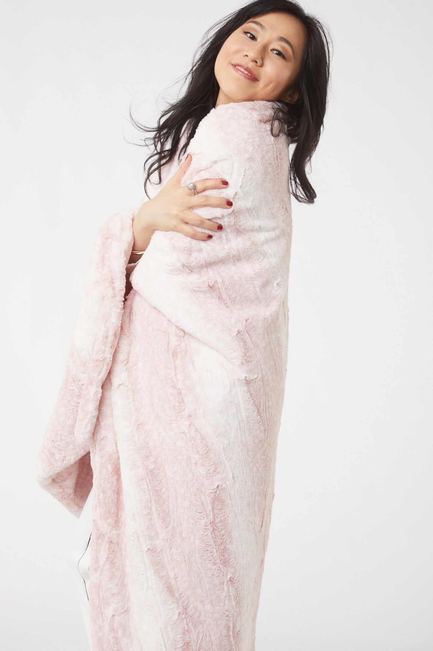 Woman wrapped with Siberian Leopard Cream and Blush Throw