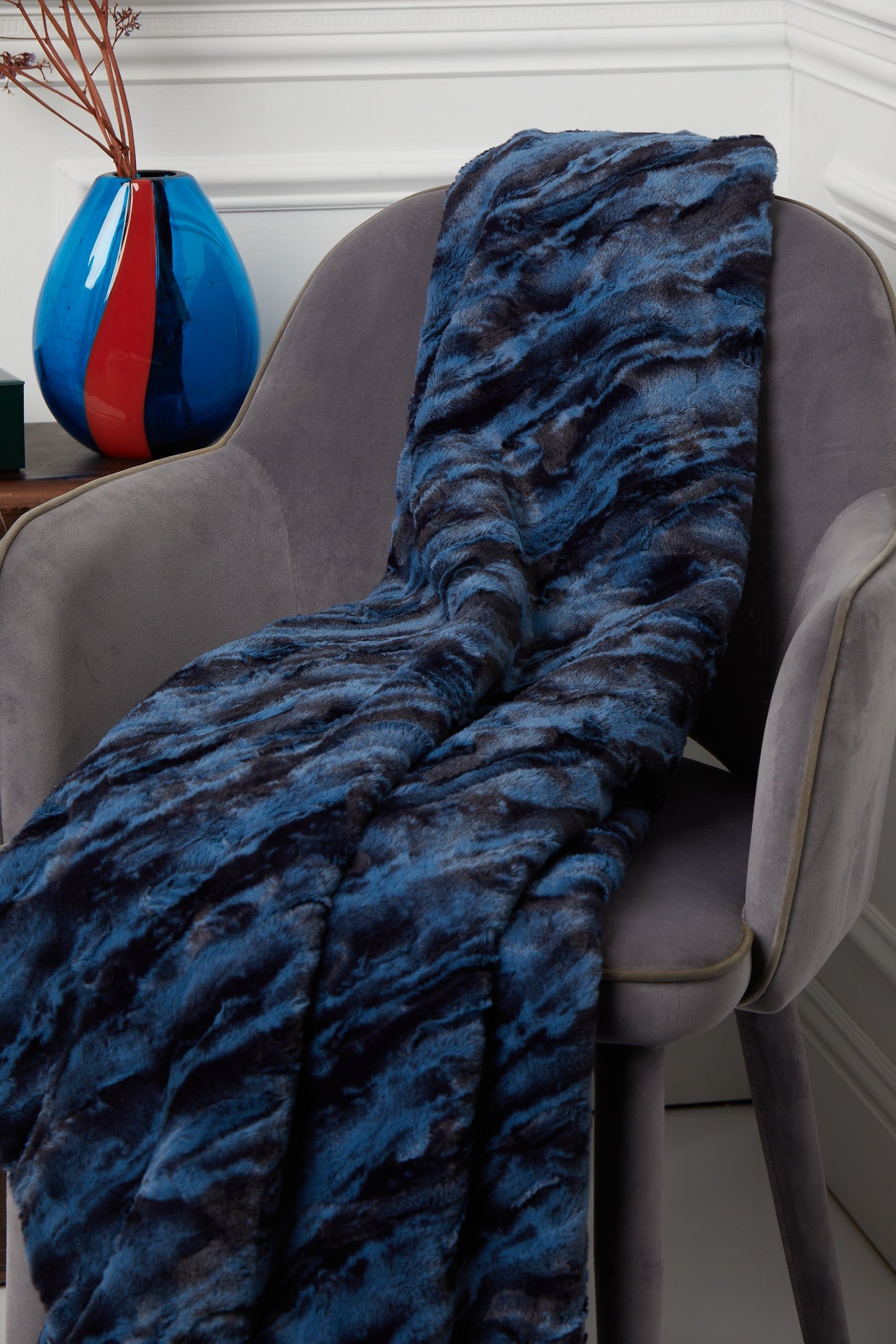 Throw – Sydney Royal Blue and Black on a grey chair