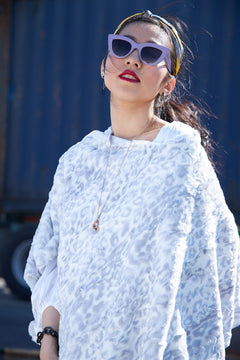 Alternative pose of a woman wearing a Cream and Silver Wild Jacquard Poncho, view 3