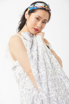 Woman posing wearing Wild Jacquard Luscious Throw – Silver, view 3