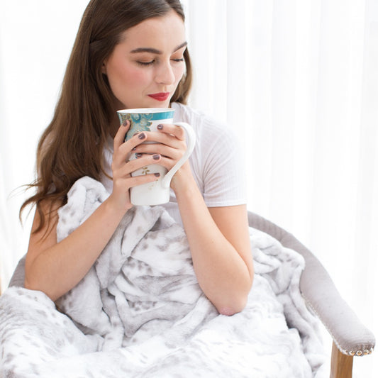 Woman drinking with Animal Print Throw in Grey Snow Leopard